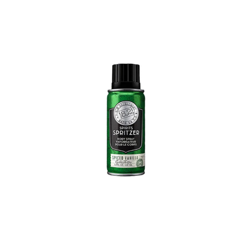 Green body spray bottle with black cap on a textured gray background