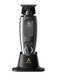 Andis electric trimmer with charging base on a white background