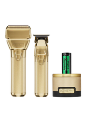 Set of gold grooming tools including a razor, trimmer, and canister on a white background