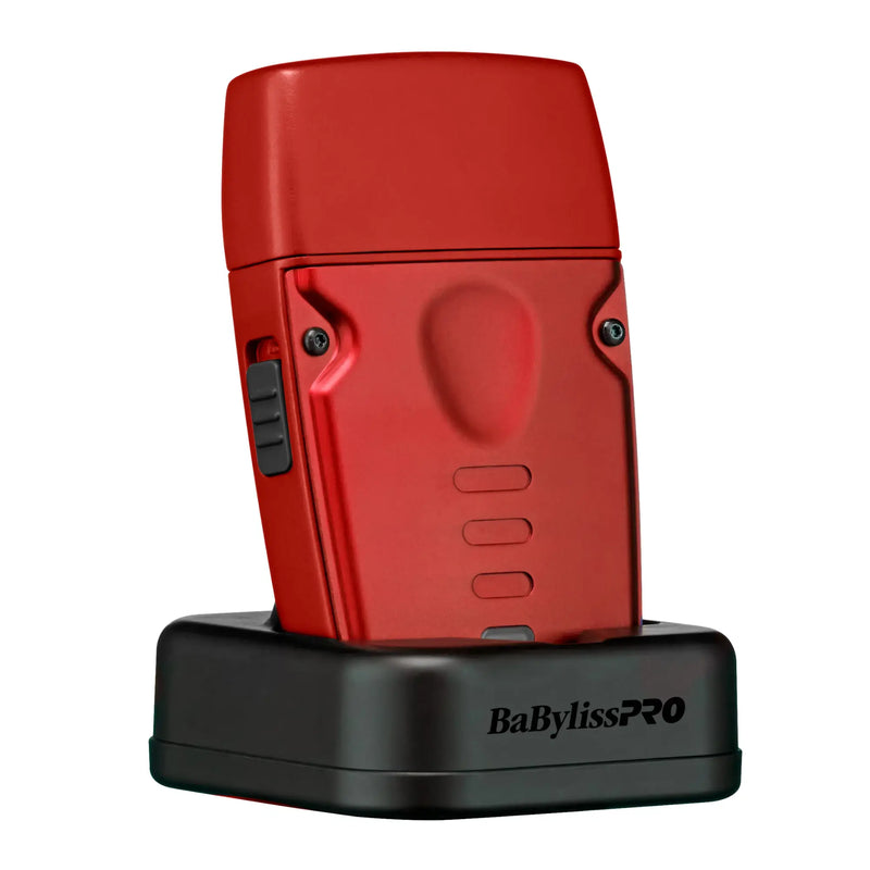 Red BaBylissPRO lo-pro compact shaver on black charging base on a white background 