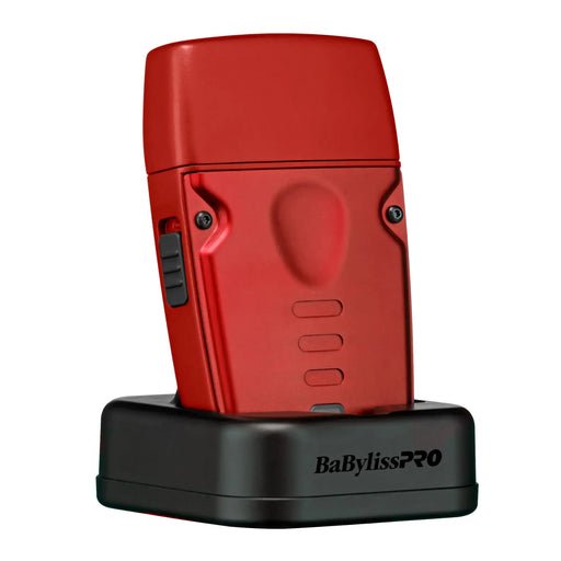 Red BaBylissPRO lo-pro compact shaver on black charging base on a white background 
