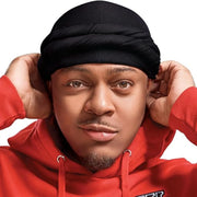 Person wearing a red hoodie and black hair turban against a white background