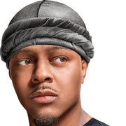 Man wearing a gray head wrap against a white background