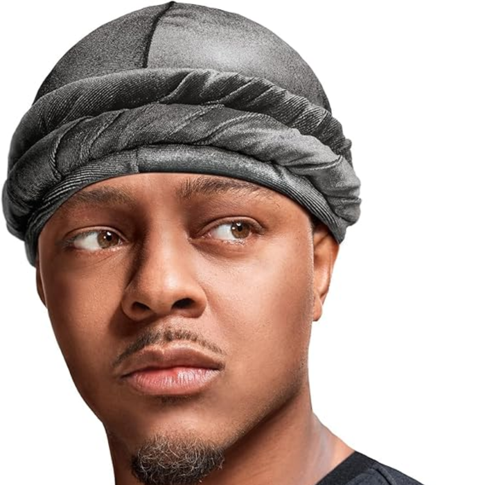 Person wearing a red hoodie and gray hair turban against a white background