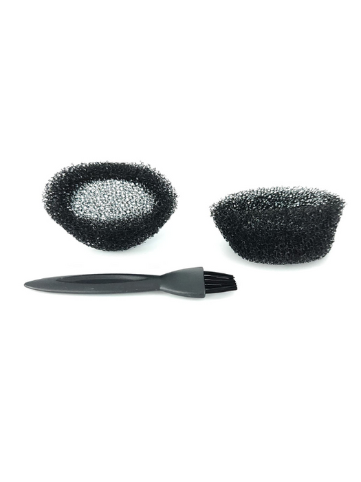 Set of three black scrub brushes with varying sizes on a white background