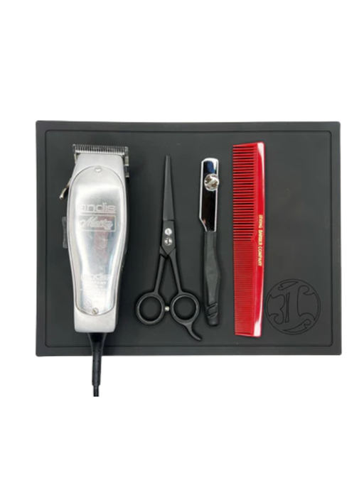 Set of hair cutting tools including a clipper, scissors, and comb on a black tray with a white background.