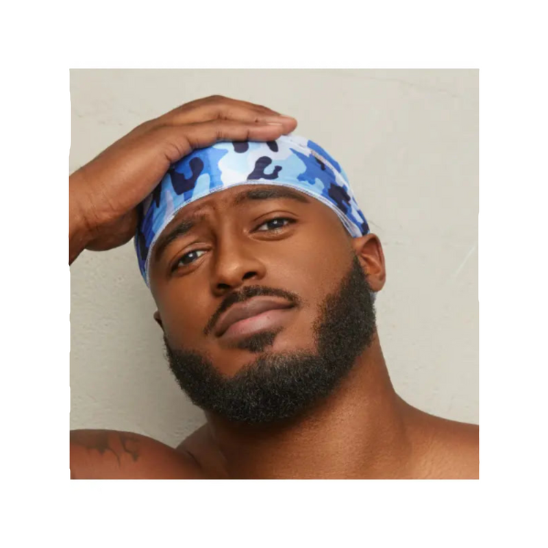 Man wearing a blue camouflage bandana with black patterns on a plain background