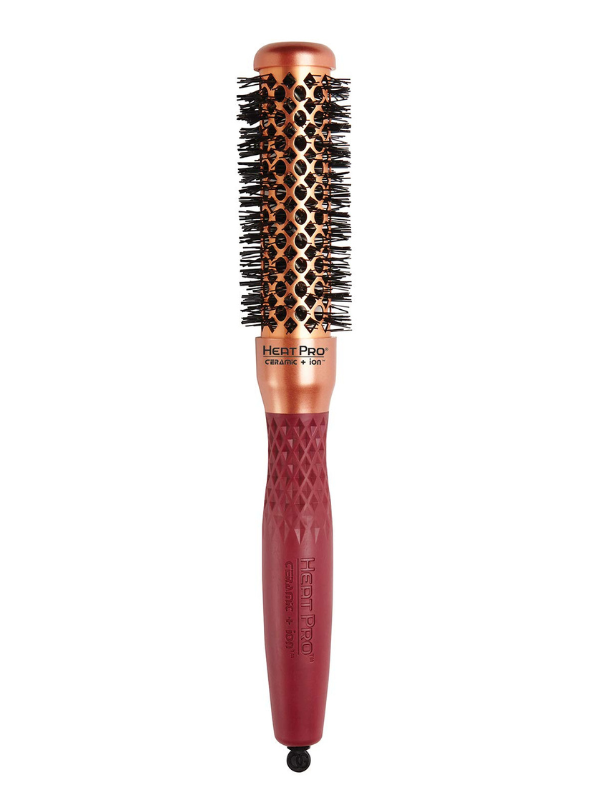 Hairbrush with copper bristle head and red handle on a white background