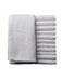 Set of gray towels, including a folded towel and a stack of rolled towels, on a white background.
