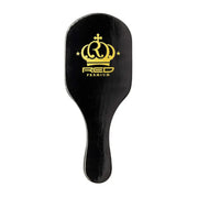 Black hairbrush with gold logo on a white background