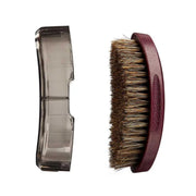 Horse brush with bristles and a clear handle on a white background