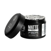 Black jar of matte paste with a decorative label on a white background