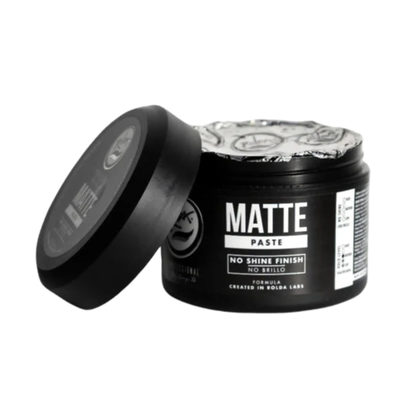 Black jar of matte paste with a decorative label on a white background