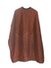 Red and brown patterned cape on a white background
