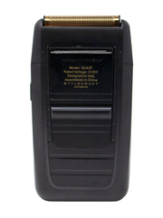 Black electric shaver with gold top on a white background