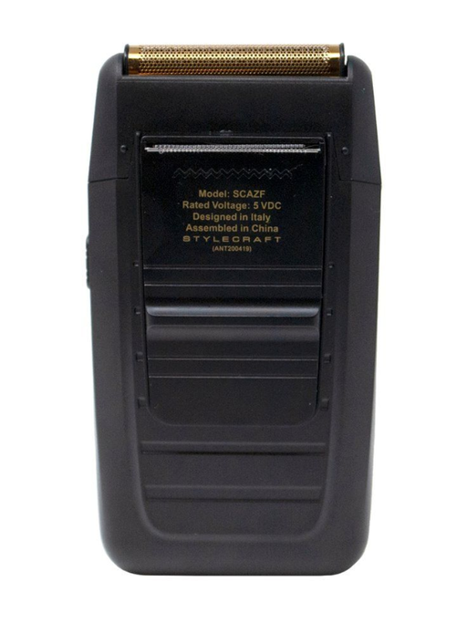 Black electric shaver with gold top on a white background