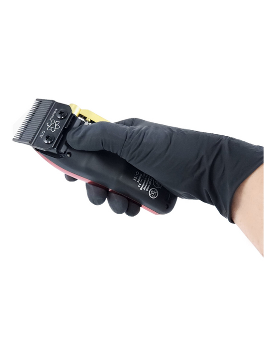 Hair clipper held by a hand wearing a black glove on a white background