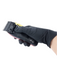 Hair clipper held by a hand wearing a black glove on a white background