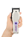 Hair trimmer held in a hand with a white background