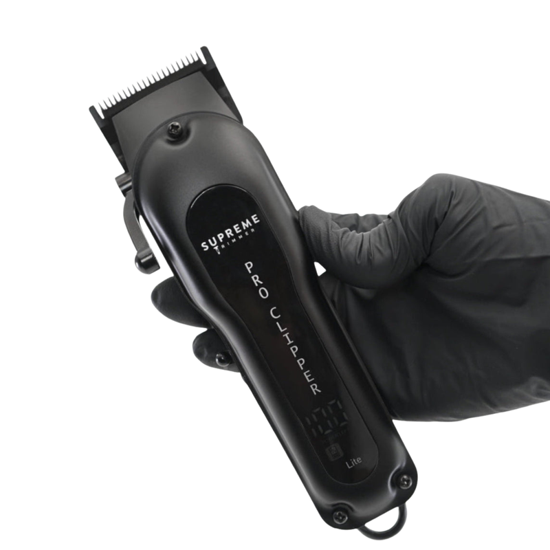 Supreme trimmer hair clippers labeled 'Supreme' on a white background held in hand 