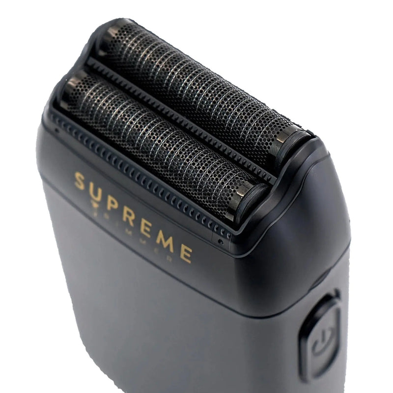 Black electric shaver with 'Supreme' branding on a white background showing shaver foils