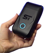 Hand holding a black Supreme Trimmer shaver with a blue power on light on a white background