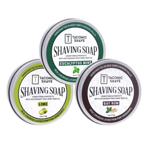 Three tins of Taconic Shave soap with different scents on a white background