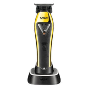 Black and gold vgr trimmer on its charging base on a white background