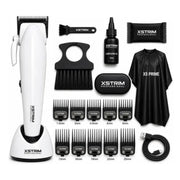 XStrim professional hair clipper kit with a white clipper on a charging base, multiple black guide combs, a black cleaning brush, a small bottle of lubricant, a black pouch, a black cape, and a USB cable, all arranged on a white background.