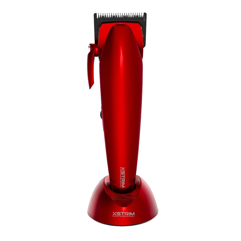 A red XSTRIM cordless hair clipper with a black cutting blade, standing upright on its matching red charging base against a plain white background.
