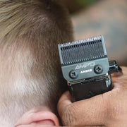 Barber using an Andis AMP'D clipper blade for detailed haircut fading