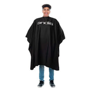 Person wearing a black Andis cape on a white background