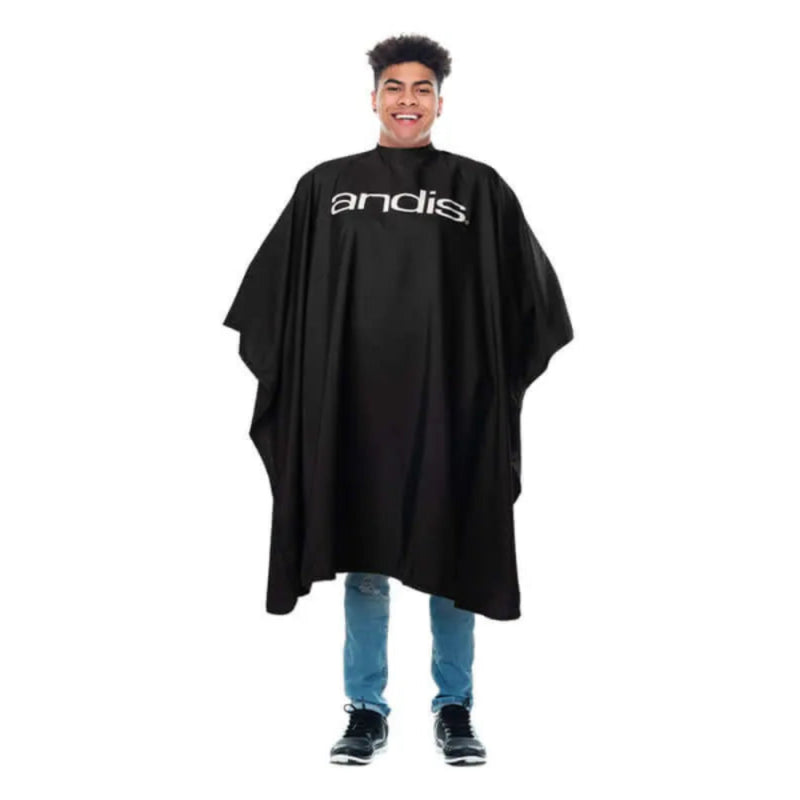 Person wearing a black Andis cape on a white background
