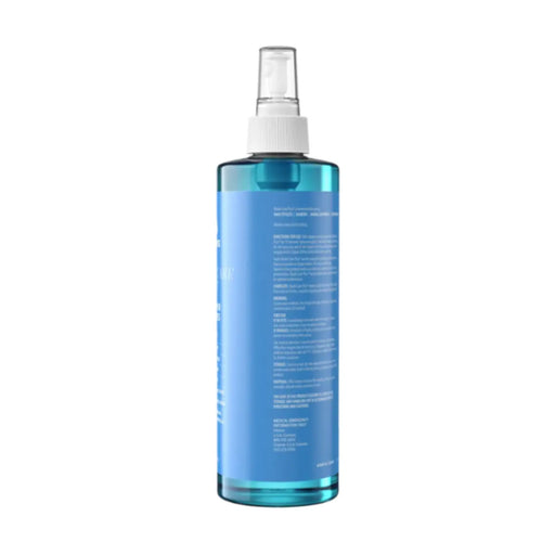 A tall, translucent blue spray bottle with a white spray nozzle and a white label, shown from the back against a plain white background.