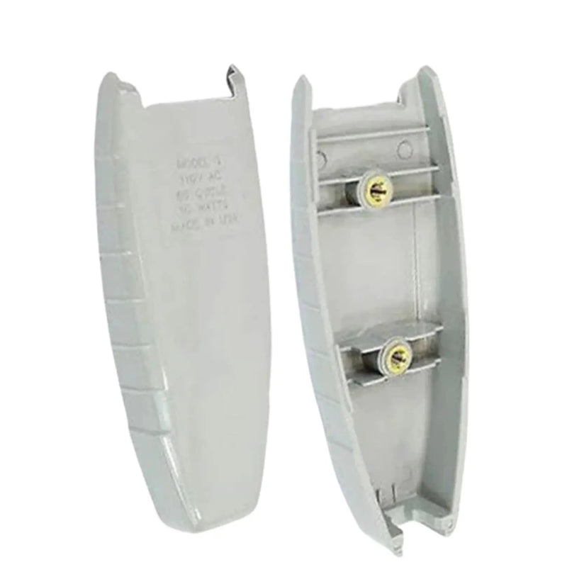 Two light gray plastic electrical components, likely switch or outlet covers, shown on a plain white background. One piece is the outer cover with printed specifications, and the other shows the inner side with two screw terminals and small gold-colored fasteners.