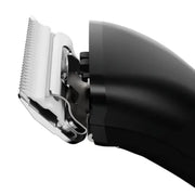 Close-up of a black electric hair clipper showing the silver metal blade and guide comb, isolated on a white background.