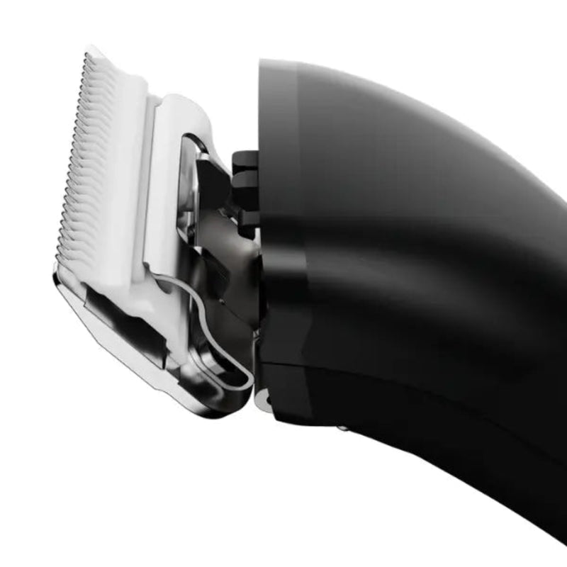 Close-up of a black electric hair clipper showing the silver metal blade and guide comb, isolated on a white background.