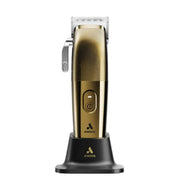 Gold ANDIS cordless hair clipper standing on a black charging base against a white background.