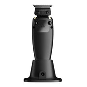 A black Andis professional clipper shown from the back, resting on its matching black charging dock against a solid white background.