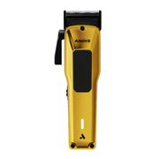 A handheld electric hair clipper in metallic gold with black accents, including the clipper head, side lever, and grip panel. The brand name 'ANDIS' is printed in black on the front, and a small illuminated indicator light is visible near the bottom.