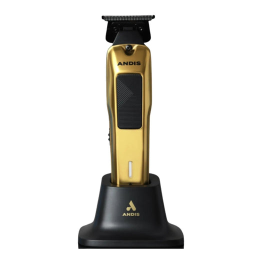 Gold and black ANDIS cordless clipper standing on a black charging base against a white background.