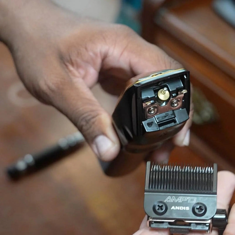 Barber installing the Andis Recon AMP'D adjustable blade on a professional clipper