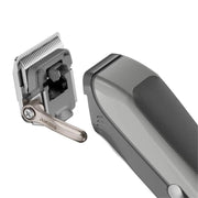 A close-up studio shot of a cordless hair clipper showing both the clipper head with exposed blades and the main handle body, on a plain white background.