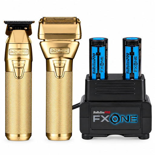 Gold Babyliss FXOne professional grooming kit with two gold devices (clippers and trimmer head) and a black charging dock with two blue batteries, on a white background.