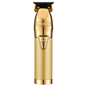 A gold-colored Babyliss Pro electric hair clipper shown vertically against a solid white background.