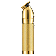 A gold-colored electric trimmer with a textured grip and polished metallic finish, shown against a plain white background.