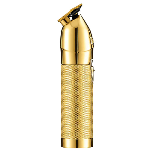 A gold-colored electric trimmer with a textured grip and polished metallic finish, shown against a plain white background.