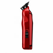 A red cordless electric hair trimmer shown from a side profile view against a solid white background.