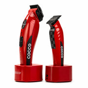 Two red Cocco electric clipper devices standing upright on matching red charging bases showing the new checker grip