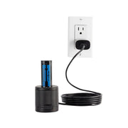 Black cylindrical device with blue label plugged into a wall outlet on a white background
